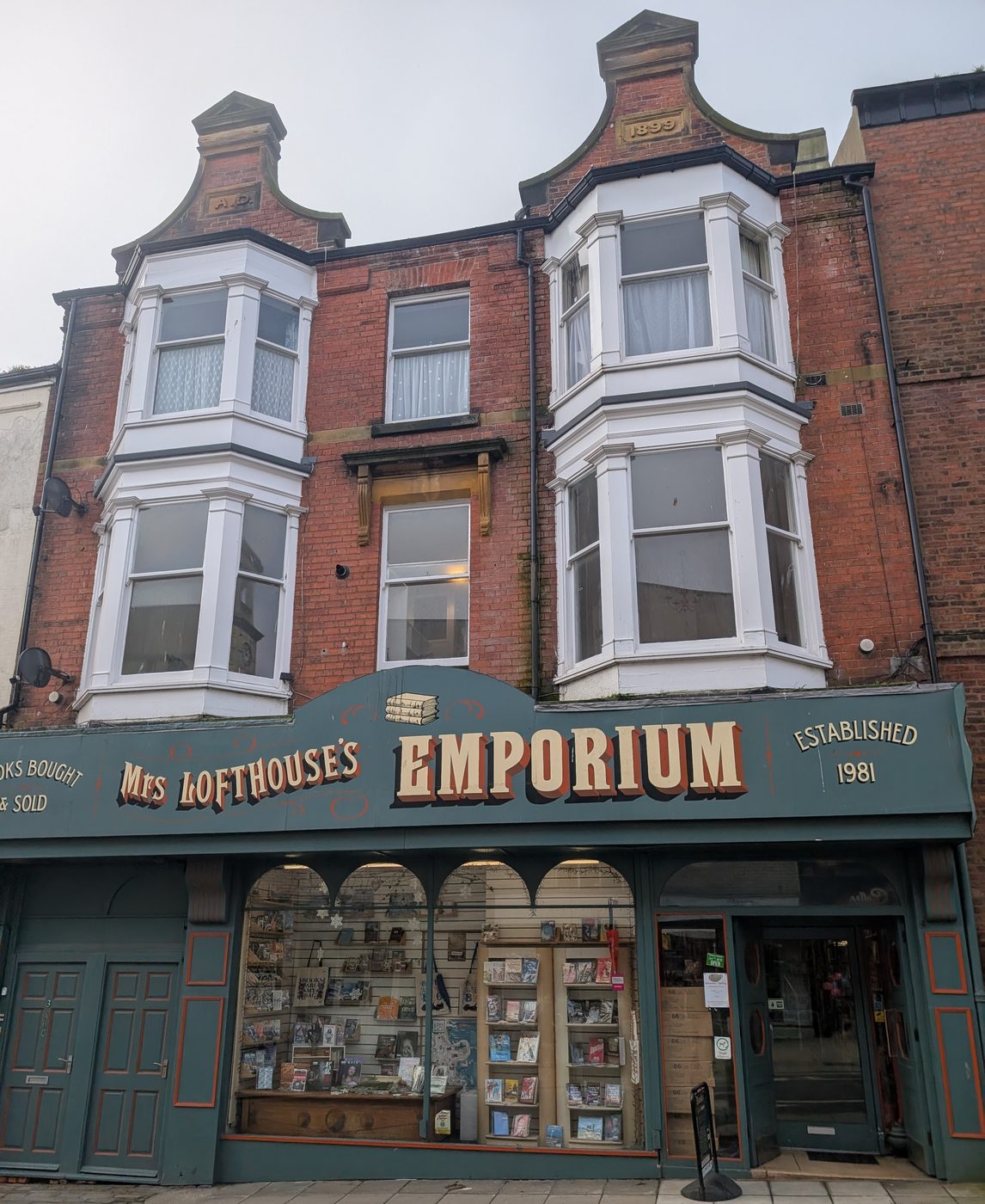 The shop at 4 Queen Street: a green-painted Victorian-style shopfront with arched windows and the sign Mrs Lofthouse's Emporium, established 1981
